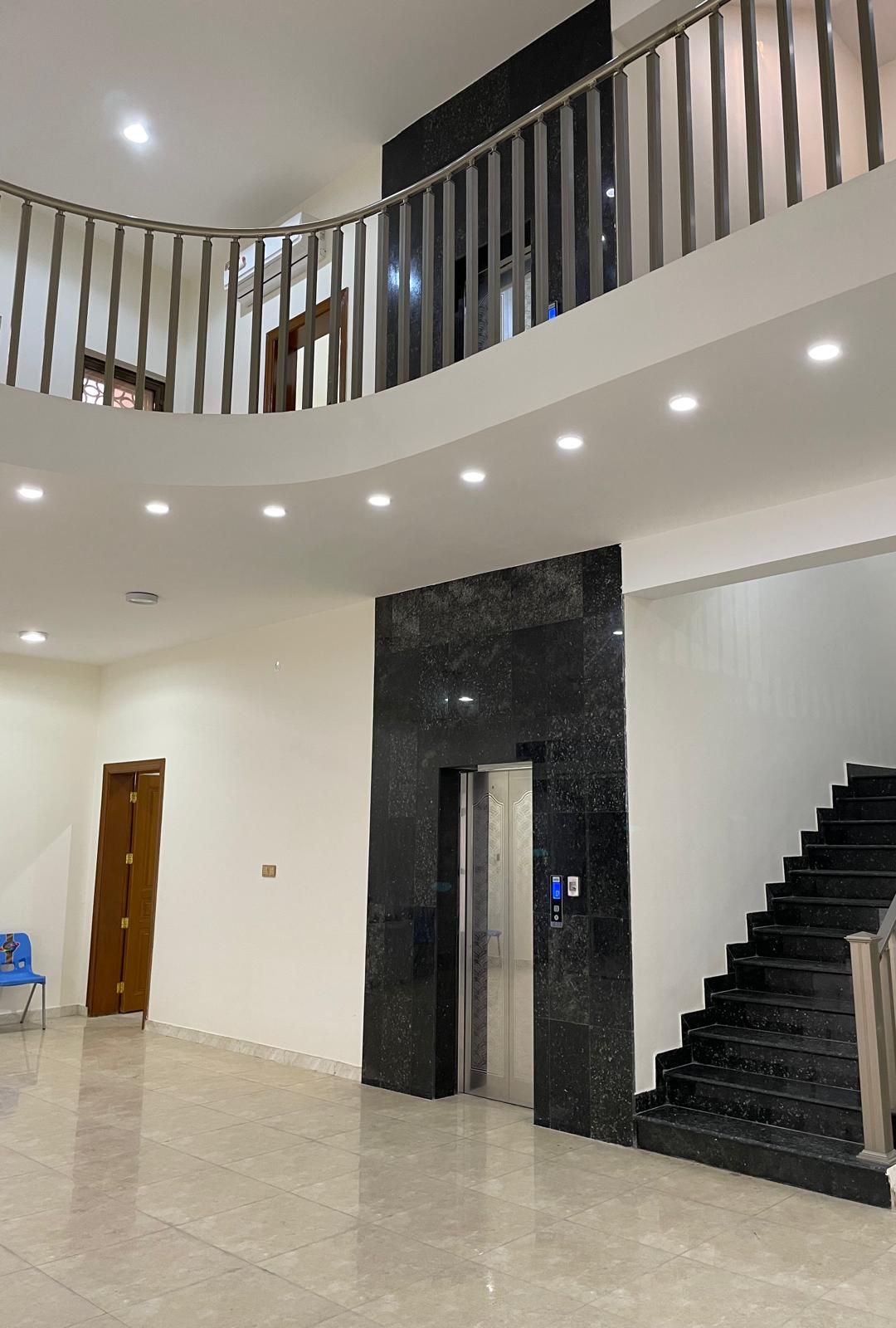 The double-height entrance hall and curved gallery landing
